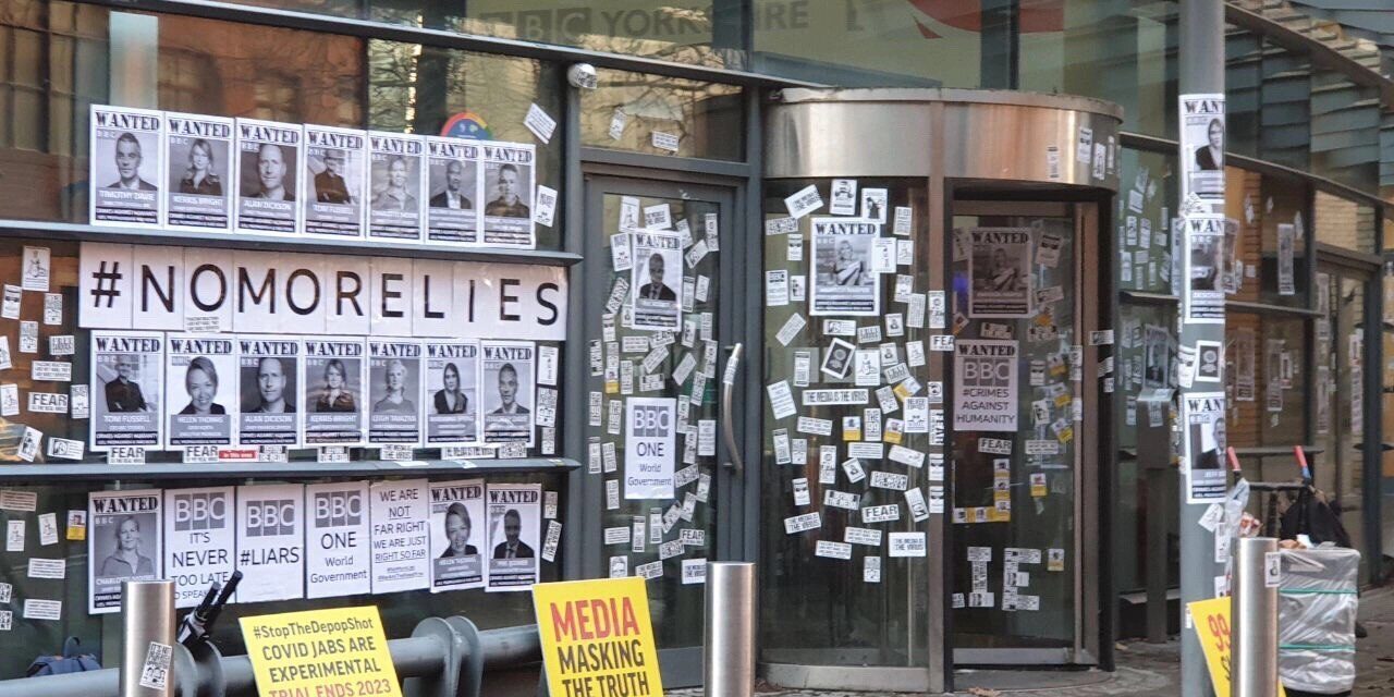 “BBC is the Virus” – At Least 6 BBC Buildings Across UK Covered with Photos of People Who Died from COVID Vaccine (VIDEO)